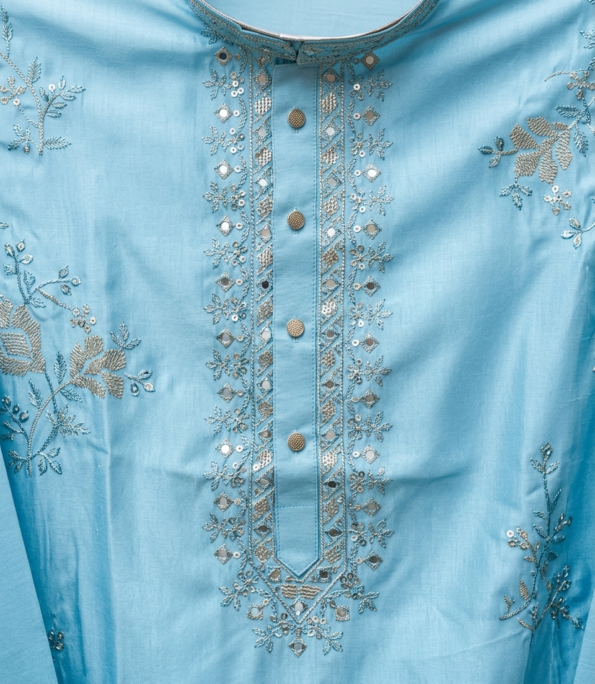 Man wearing sky blue embroidered kurta with white pants and tan sandals (2)
