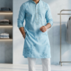 Man wearing sky blue embroidered kurta with white pants and tan sandals (2)